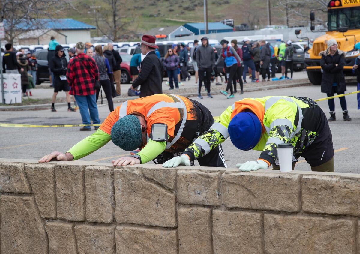 People stretch before the start of the Race to Robie Creek on Saturday, April 26, 2022.