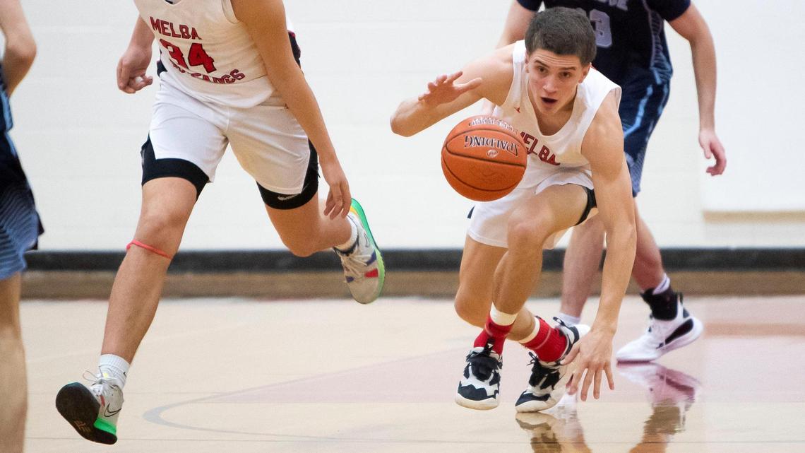 Melba guard Joe Reiber grabs a loose ball after an Ambrose turnover on Feb. 4. The 2A WIC rivals meet in the first round of the 2A state tournament Thursday at Capital High.