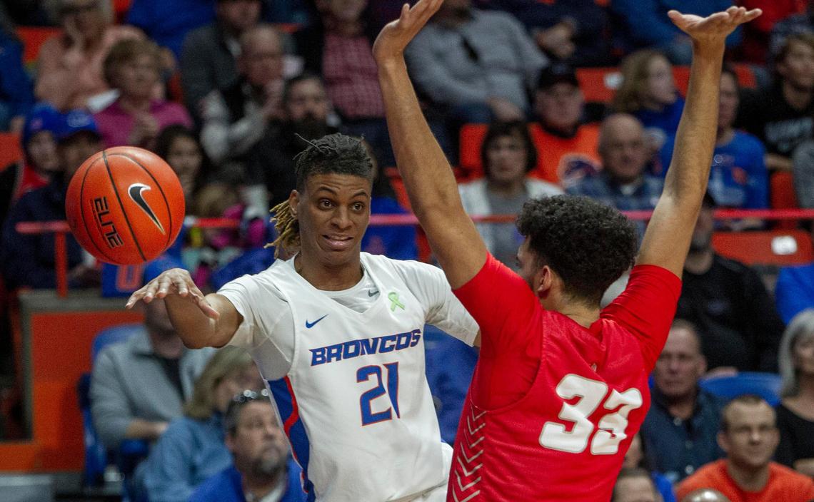 Boise State guard Derrick Alston sidearms an assist to teammate RJ Williams in the paint while guarded by New Mexico forward Jordan Arroyo Sunday, Feb. 23, 2020 at ExtraMile Arena in Boise.