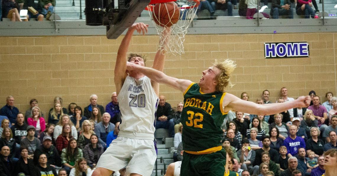 Rocky Mountain’s Briggs Ranstrom finds the basket against Borah’s Austin Bolt in the final minutes of Rocky’s 50-38 win over Borah for the 5A district championship on Friday, Feb. 28, 2020.