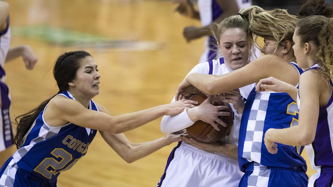 Caldwell guards Jade Martinez (20) and Courtney Williams fight to get the ball from Century’s Ashton Adamson in the state 4A girls basketball championship Saturday, Feb. 16, 2019 at Ford Idaho Center in Nampa.