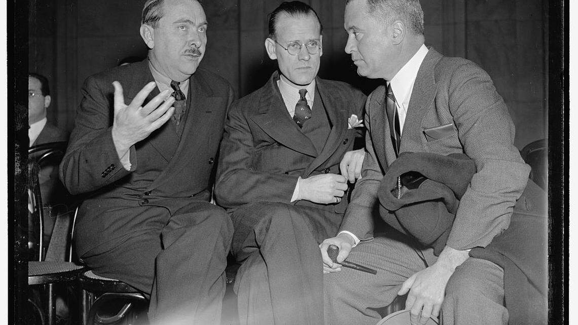 Philo T. Farnsworth (middle), the first inventor to demonstrate an electric television, discusses the difficulties of securing patents with his company secretary, George Everson (right), and Richard C. Patterson Jr., federal assistant secretary of commerce (left), on Jan. 19, 1939, in Washington, D.C.