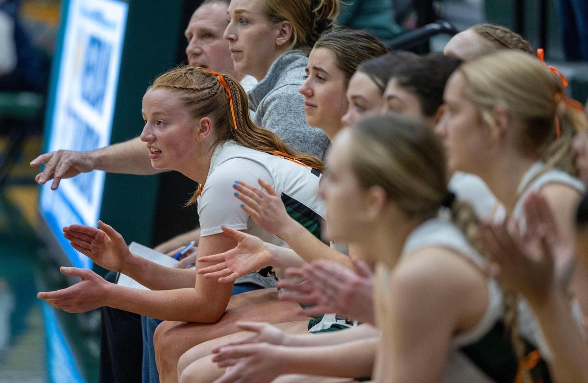 Audrey Baxter cheers for her teammates during a girls basketball game Thursday at Eagle High School.