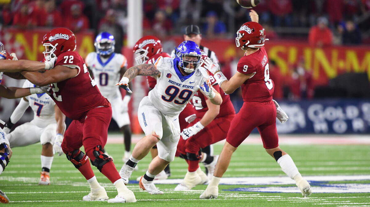 Boise State defensive tackle Scott Matlock puts pressure on Fresno State quarterback Jake Haener during the Broncos' 40-14 win over the Bulldogs last season in Fresno, California. 