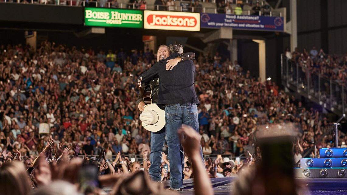 Garth Brooks, holding his cowboy hat, shares a hug with Blake Shelton during the concert July 19 at Albertsons Stadium in Boise.