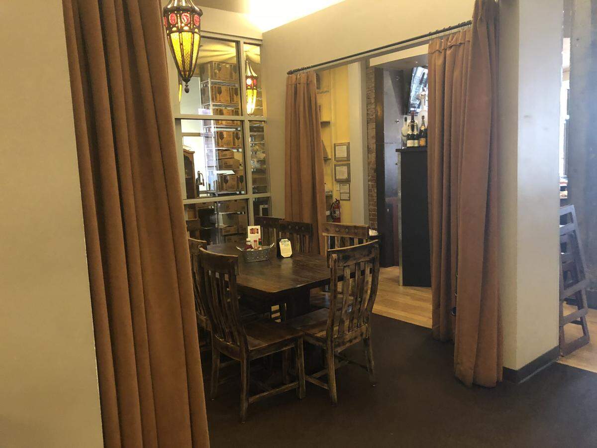 Bacon has a room with curtains in the back,near where customers place their orders. Owner John Berryhill said he closed one set of curtains after talking with a group of men who were openly carrying their guns on Feb. 21.