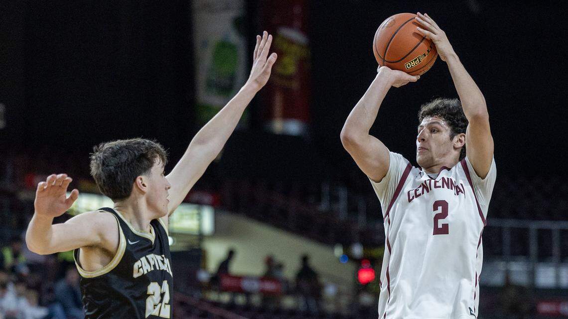 Centennial guard Gabe Eddins hits a jump shot defended by Capital's Daiken Lowe. Eddins lead all scorers in the game with 26 points, leading the Patriots to a 71-53 win over the Eagles in the 6A state boys basketball tournament at Ford Idaho Center in Nampa, Thursday, March 5, 2026.