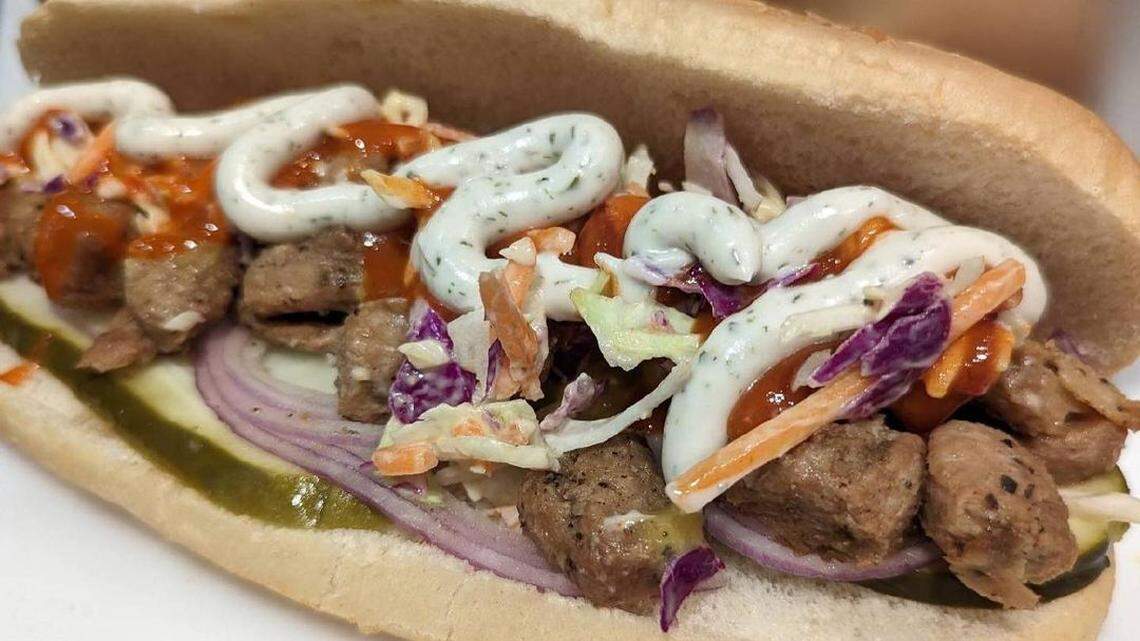 The Buffalo: chopped “chicken,” two pickle slices, sliced red onion, cole slaw, cheddar sauce, buffalo sauce and house ranch.