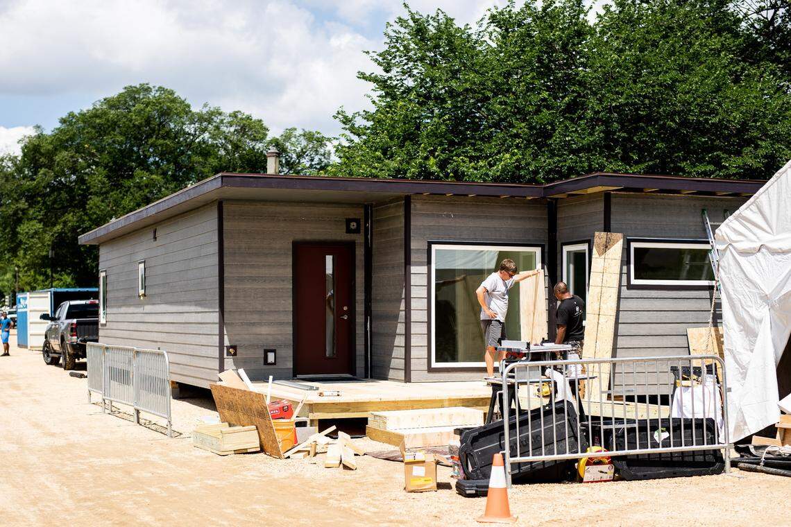 Workers from IndieDwell prepare a container home before the start of a five-day conference on affordable housing options on the National Mall in Washington, D.C.