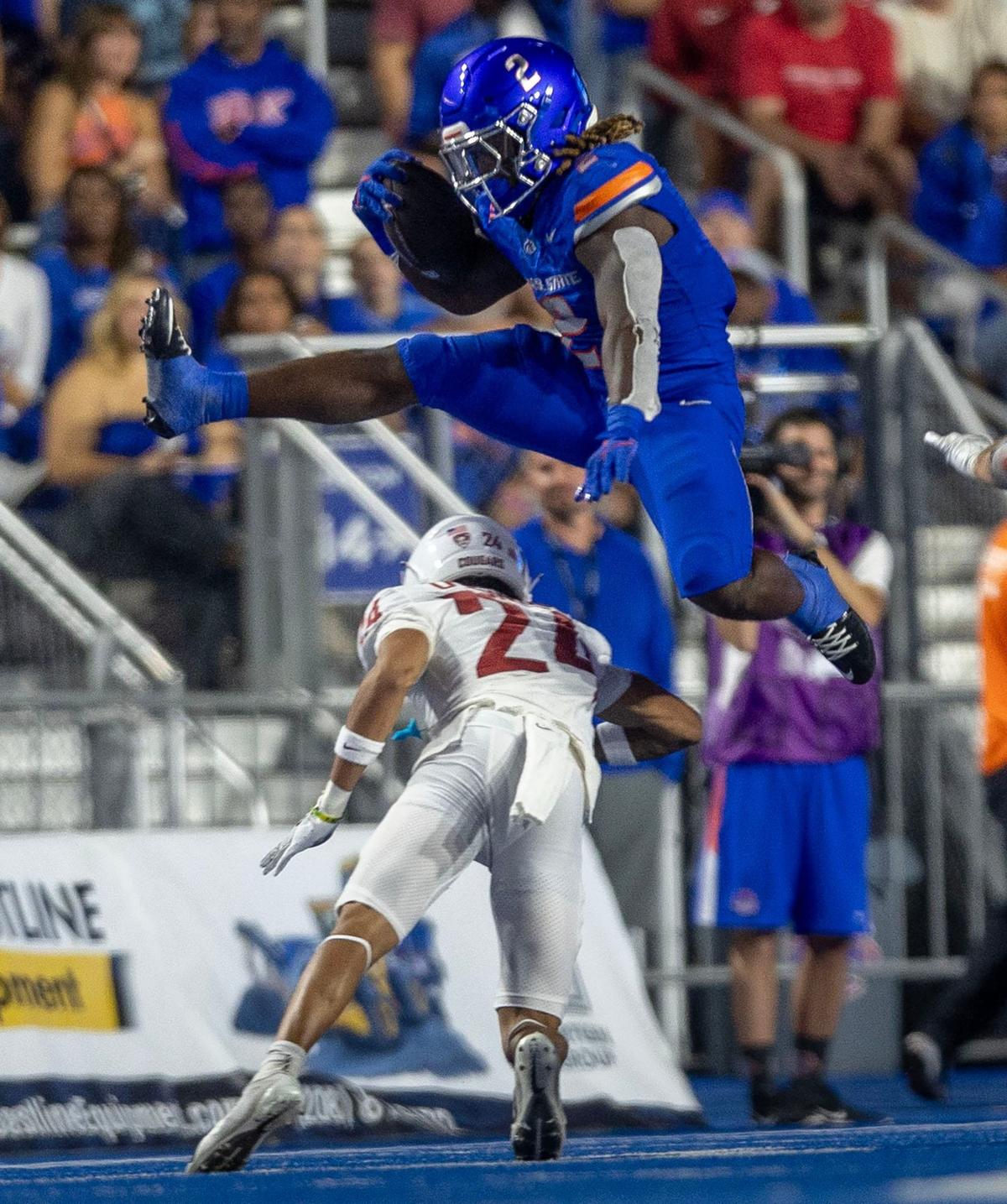 Boise State running back Ashton Jeanty hurdles Washington State defensive back Ethan O’Connor for a first down gain in the 2nd quarter at Albertsons Stadium in Boise, Saturday, Sept. 28, 2024.