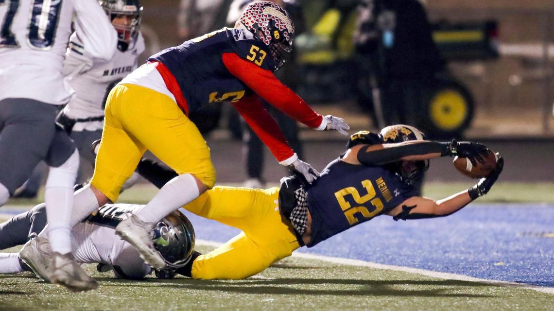 Meridian running back Rylie Byington reaches across the end zone for one of his three touchdowns Friday.