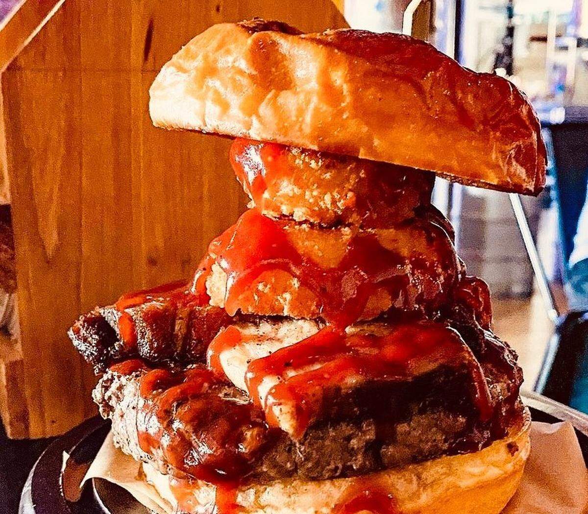 The Boss Hog is among the customer favorites at Sid’s Garage with 48-hour braised pork belly, onion rings and a scratch-made sriracha-bourbon sauce on a toasted brioche bun.