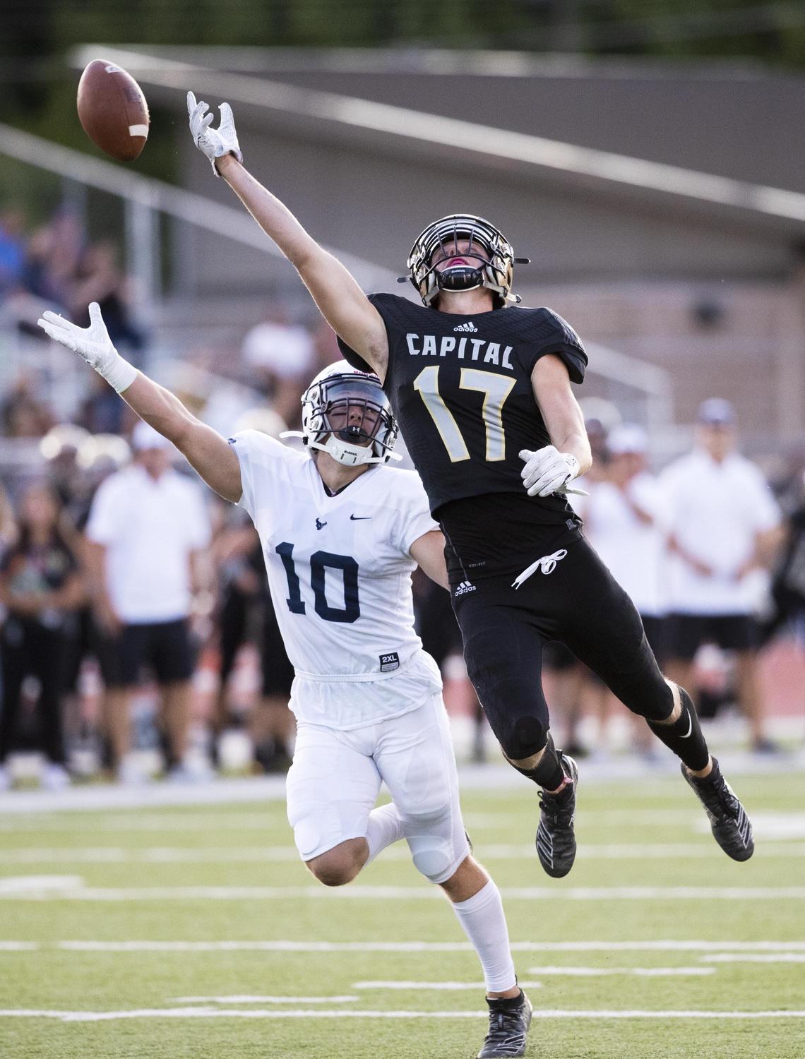 Capital wide receiver Jonah Blackham stretches, but can’t reach a high pass defended by Mountain View’s Chase Norton Friday, Sept. 13, 2019 at Dona Larsen Park in Boise.