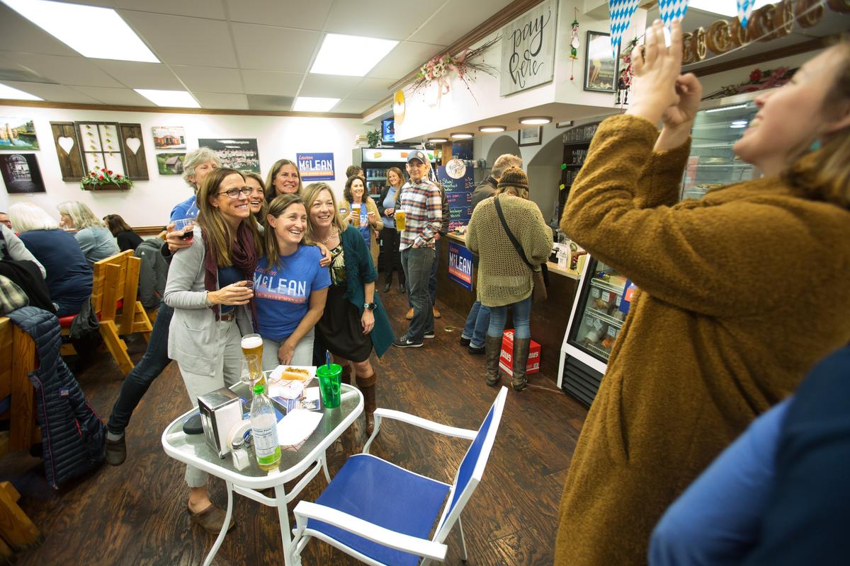 Lauren McLean (in green) poses for a photo during an election returns watch party at Das Alpenhaus and her campaign headquarters.