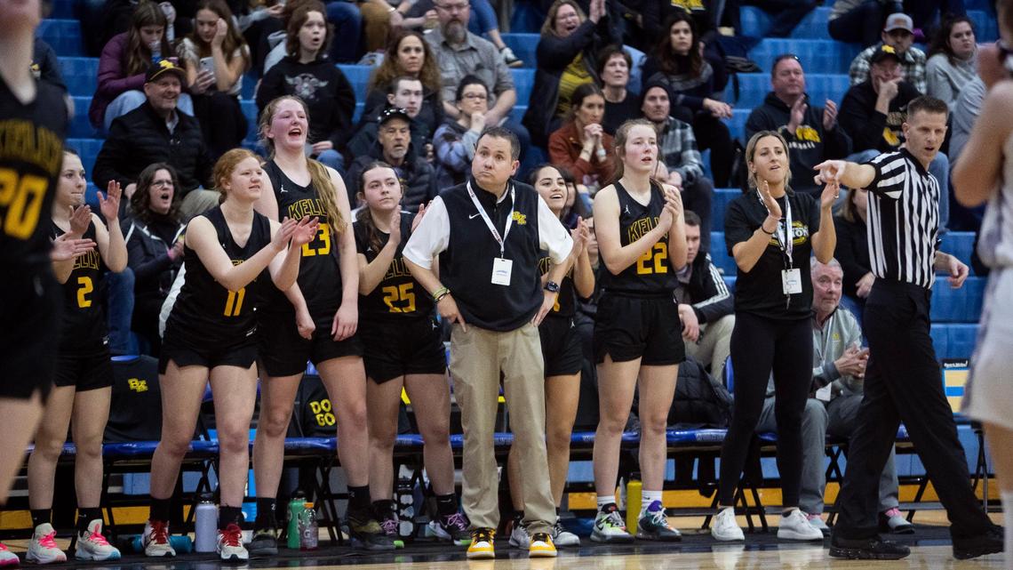 Bishop Kelly girls basketball coach Derek McCormick, center, and players on the bench react to a foul called during the 4A state girls basketball tournament quarterfinals on Thursday at Timberline High School. Bishop Kelly won 51-33 over Pocatello.