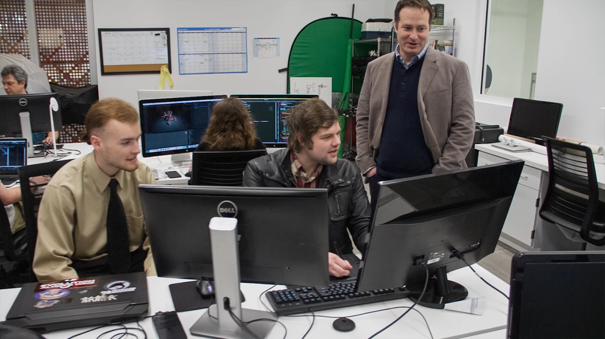 Undergraduates and faculty at the University of Idaho worked together to create the programming, music and visuals for Project Hastur. Here Professor Barrie Robinson works with students Landon Wright and Cameron Perry.