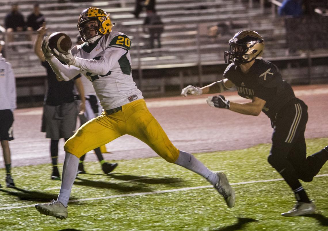 Chase Nett brings home a 28-yard touchdown pass behind Capital’s Alec Bindner to give the Lions a 21-10 lead in the third quarter.