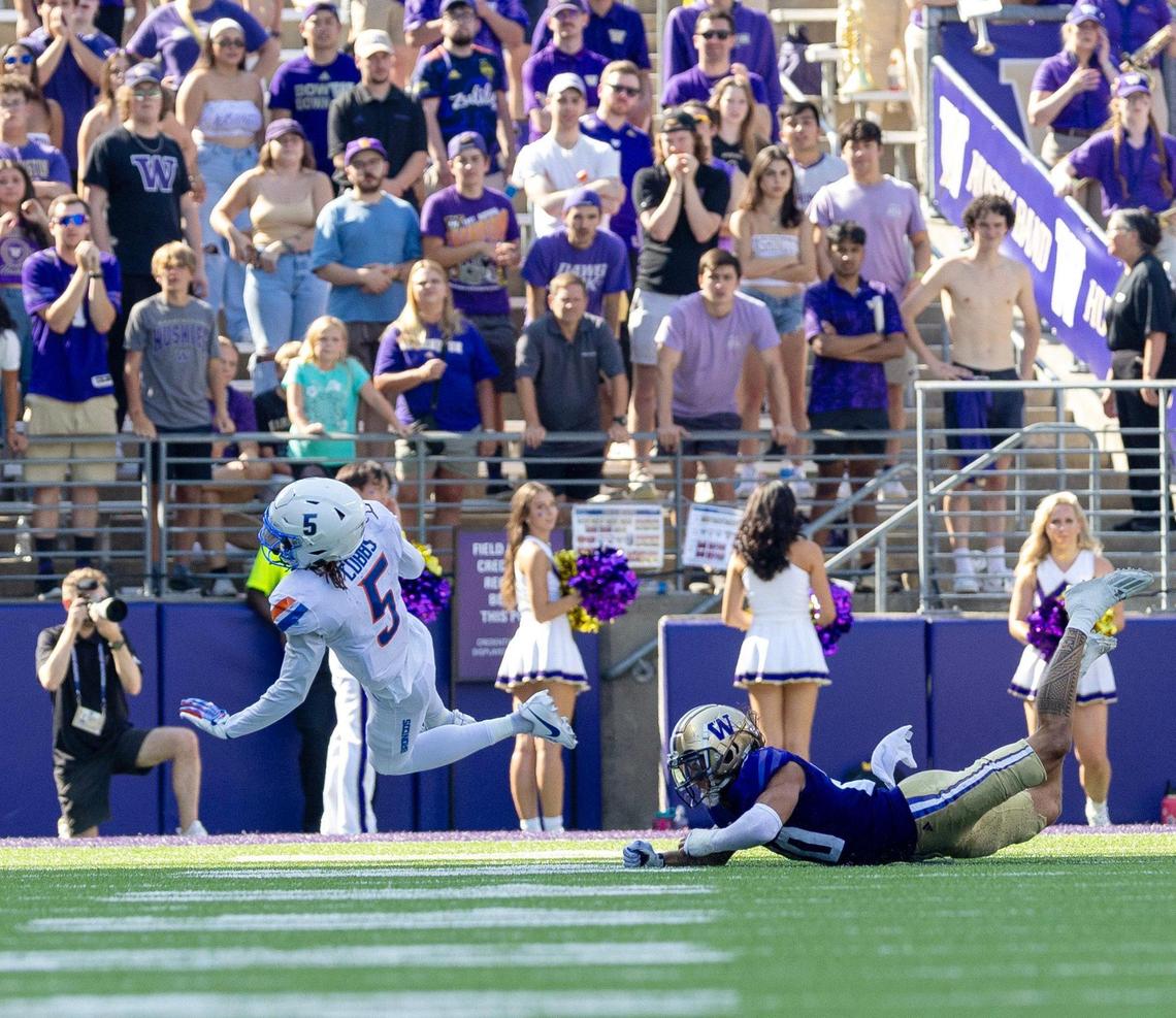 Boise State wide receiver Stefan Cobbs is tripped up by Washington safety Asa Turner in the fourth quarter.
