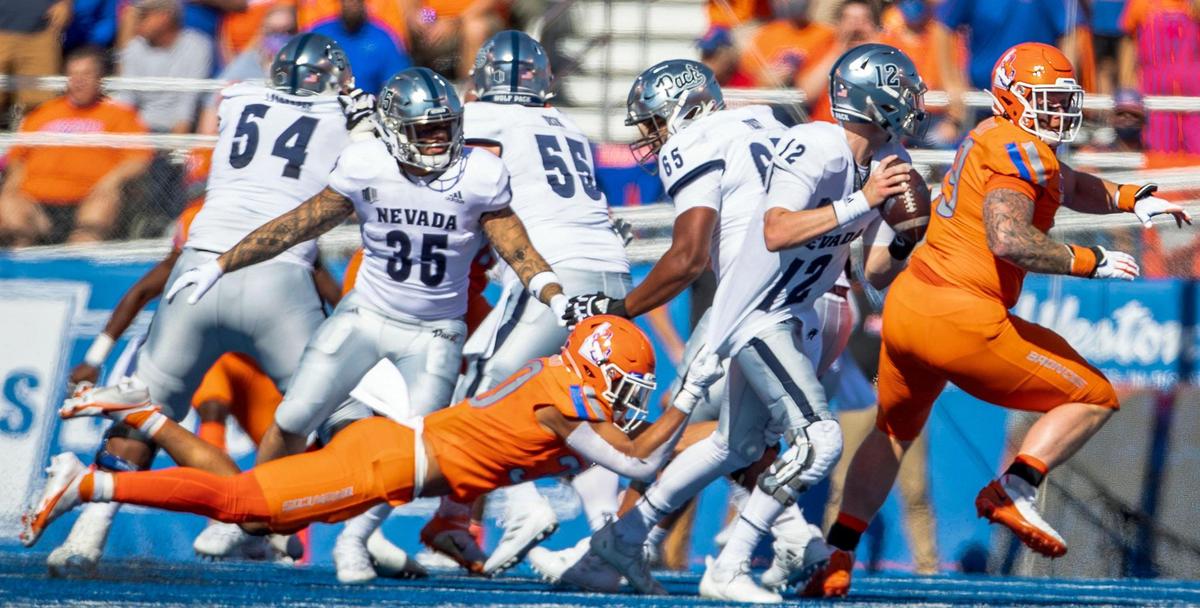 Boise State safety JL Skinner grabs the jersey of Nevada quarterback Carson Strong during the second half Saturday, Oct. 2, 2021 at Albertsons Stadium.