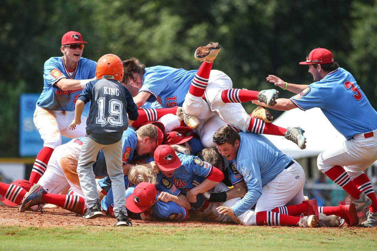 The Idaho Falls Bandits dog pile on top of pitcher Andrew Gregersen after clinching the first American Legion World Series championship in Idaho history.