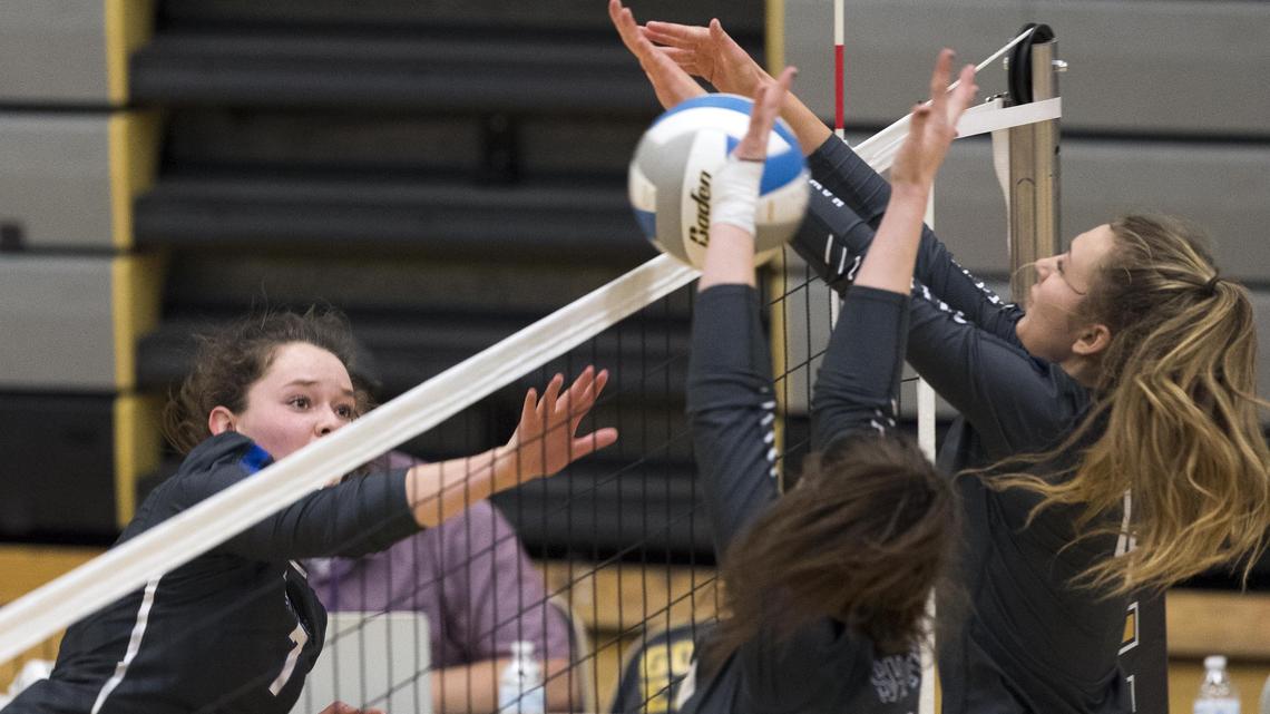 Timberline senior Miranda Lamb powers a point through a block by Skyview’s Karen Murphy (4) and Molly Anderson (10) during the 5A District Three championship Oct. 18 at Capital High.