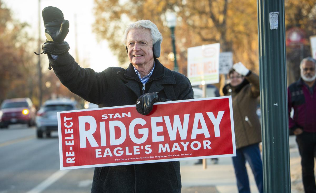 Current Eagle Mayor Stan Ridgeway, running for re-election, waves to early morning commuters at Eagle Road and State Street.