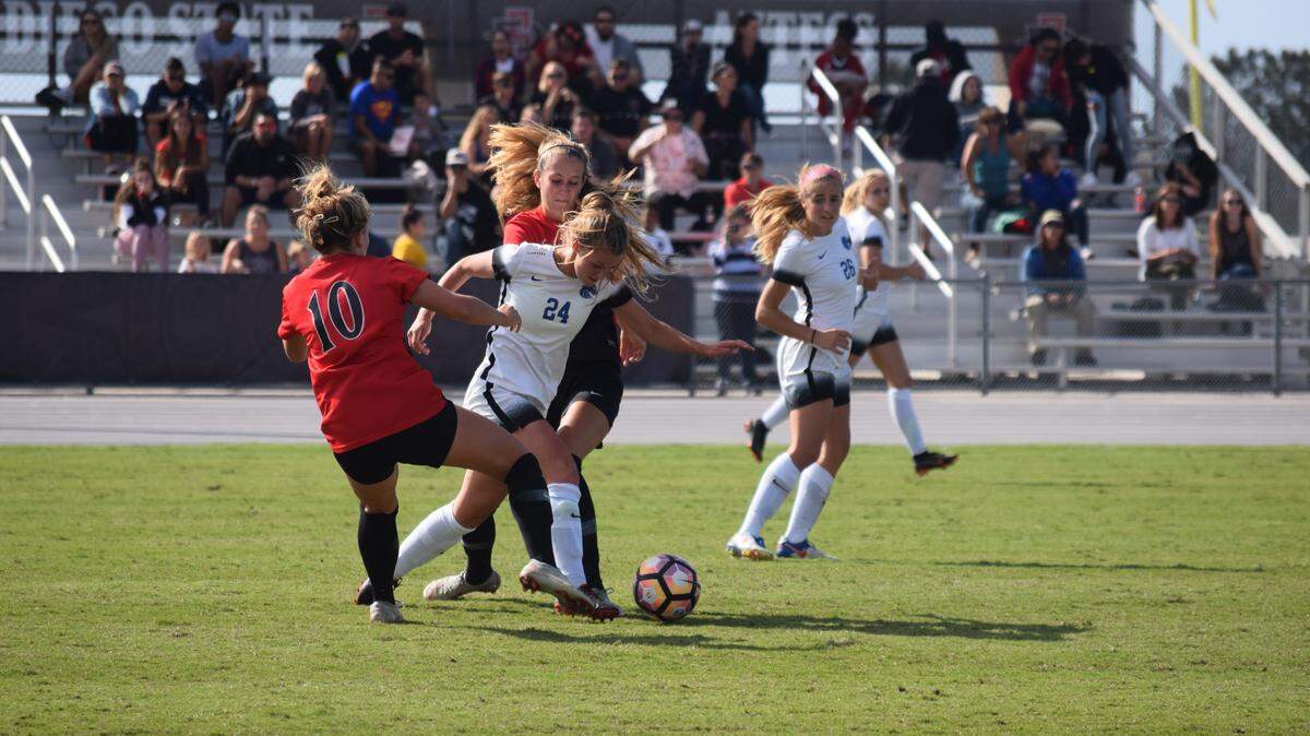 Sophomore Ashleigh Harrison fights for the ball between two San Diego State defenders on Sunday in San Diego, California. Boise State won the match 1-0.