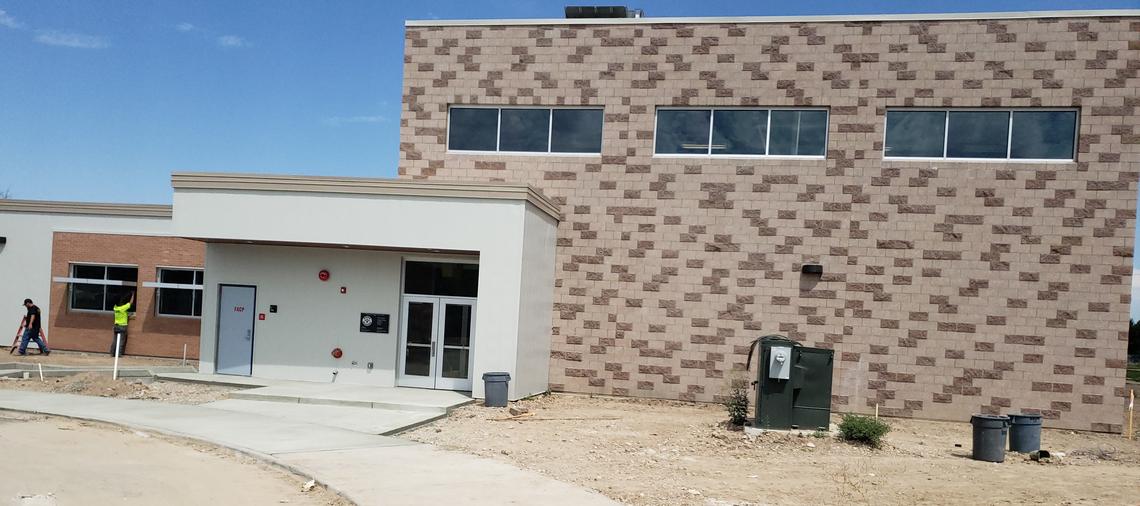 A crew works on the windows of the new cafeteria-gymnasium at Maple Grove Elementary School.