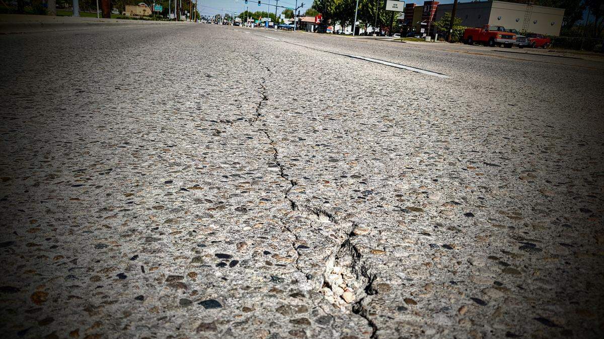 Asphalt cracks on the road in front of Idaho Transportation Department headquarters on State Street in Boise.
