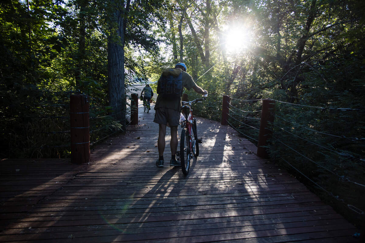 Homeless people in Boise may bicycle from place to place. Susan Pappas and Mark Hennessy get on their bicycles on the Ninth Street “dock” by the Greenbelt in Boise in August.