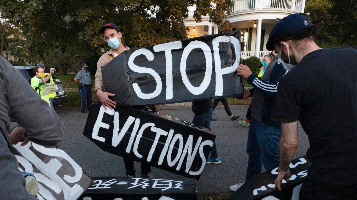 FILE - In this Oct. 14, 2020, file photo, housing activists erect a sign in Swampscott, Mass. A federal freeze on most evictions is set to expire soon. The moratorium, put in place by the Centers for Disease Control and Prevention in September, was the only tool keeping millions of tenants in their homes. (AP Photo/Michael Dwyer, File)