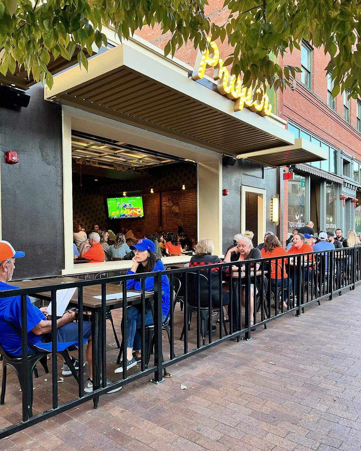 Customers sit on the patio outside the multi-concept destination on Idaho Street.