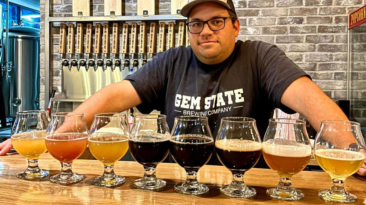 Gem State Brewing co-owner and brewer Chris McGinnis poses in front of launch beers.