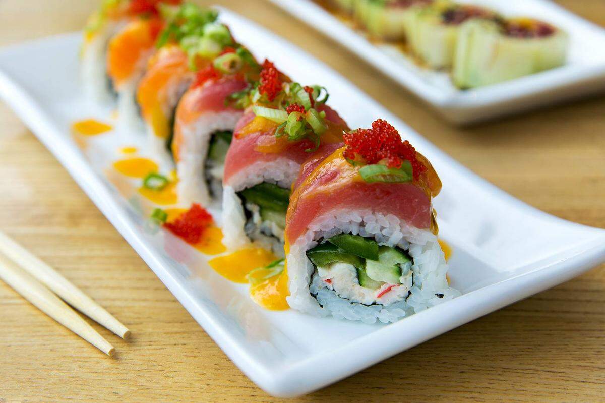 The 208 Roll ($6.99) is salmon, ahi, surimi crab salad, cucumber, jalapeño, tobiko, mango-habanero sauce, sesame seeds and green onion.