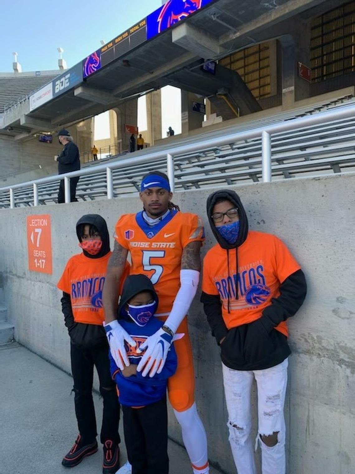 Boise State wide receiver Stefan Cobbs poses with three of his four younger brothers after a game at Albertsons Stadium.