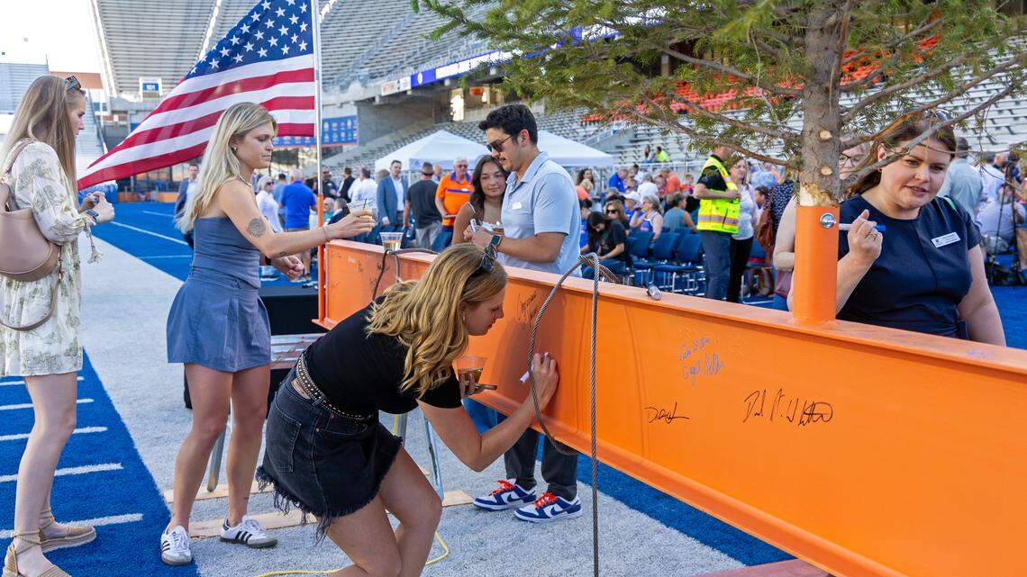 People sign the last beam at the Topping Off Ceremony for Boise State University’s North End Zone Project, Friday, May 30, 2025 at Albertsons Stadium.