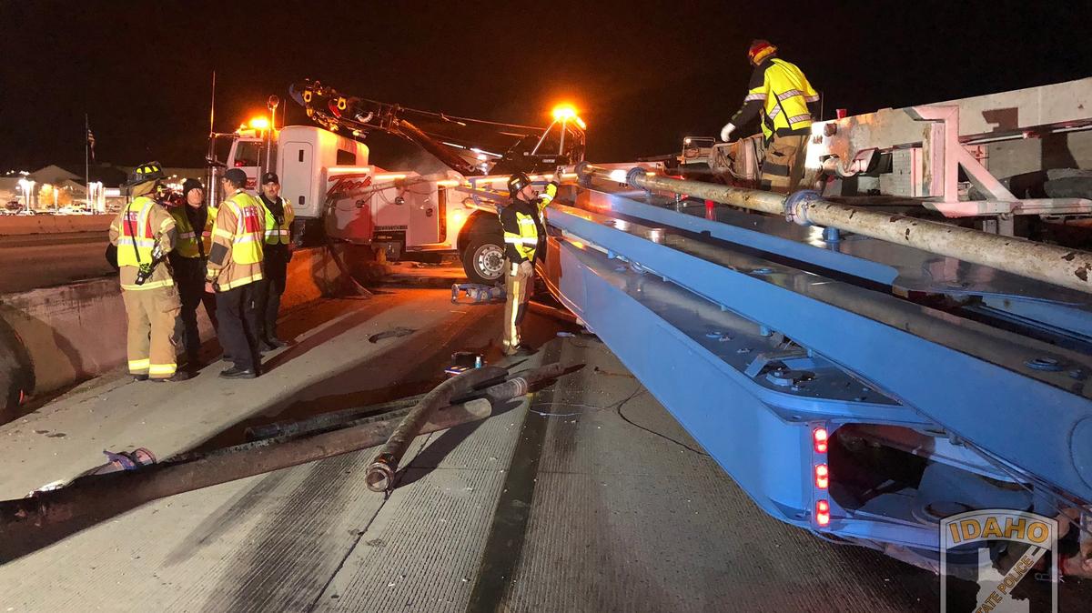 A tow truck carrying a cement truck collided with the center barrier on Interstate 84 in Nampa on Tuesday evening, closing lanes to traffic in both directions.
