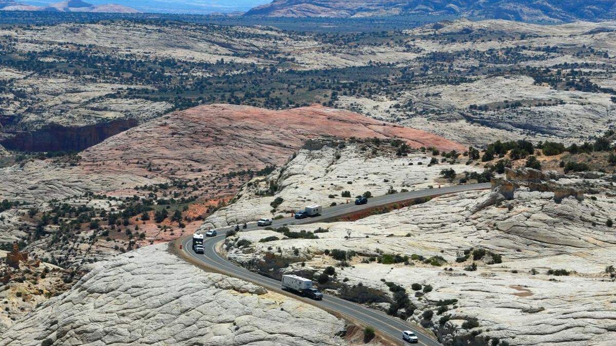 BOULDER, UT - MAY 11:  Campers and cars make their way down sandstone cliffs on Highway 12 near Hells Backbone and Calf Creek area of the Grand Staircase-Escalante National Monument on May 11, 2017 outside Boulder, Utah. The newly created Bears Ears National Monument and the Grand Staircase-Escalante National Monument are under review by the Trump Administration to help determine their future status. (Photo by George Frey/Getty Images)