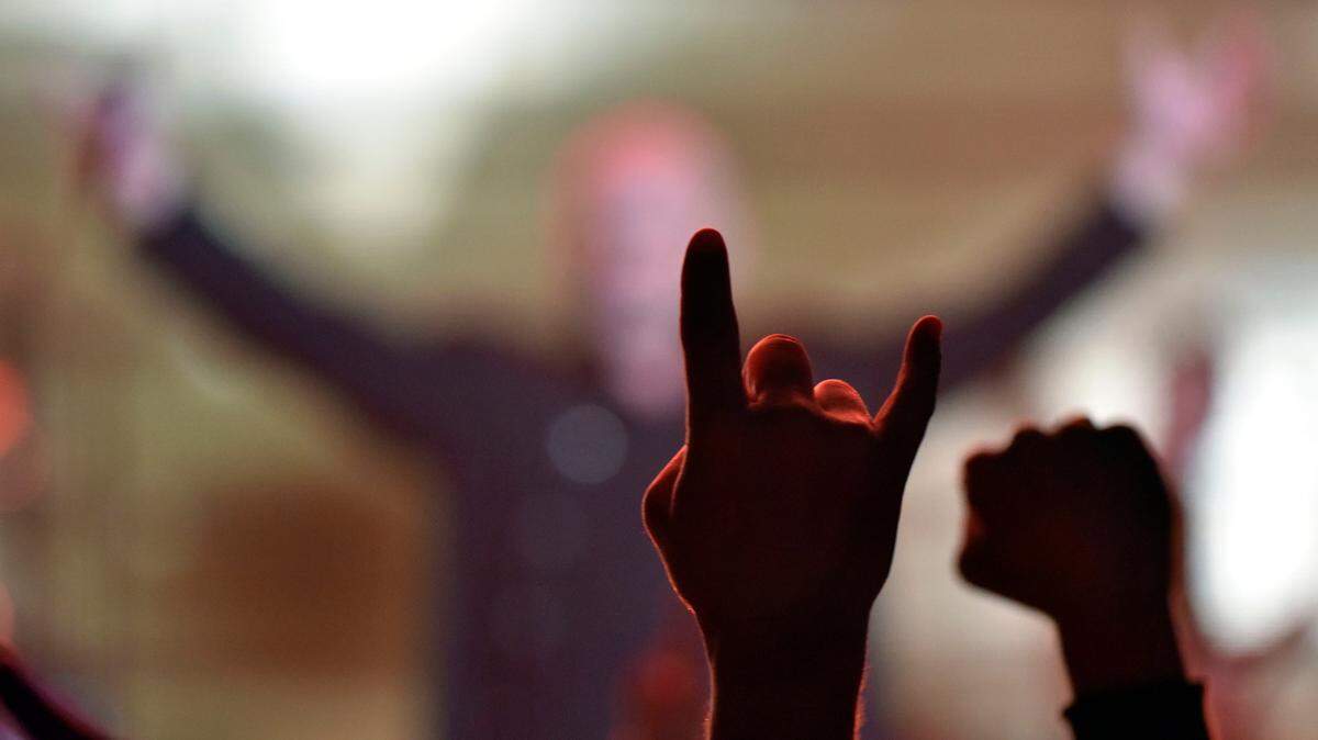 Singer David Draiman of the band Disturbed urged crowd members to raise their hands at a concert earlier this month in Rosemont, Illinois.