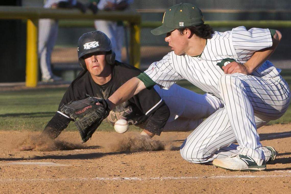 Jackson Cluff slides safely into home plate during a 2015 game vs. Borah.