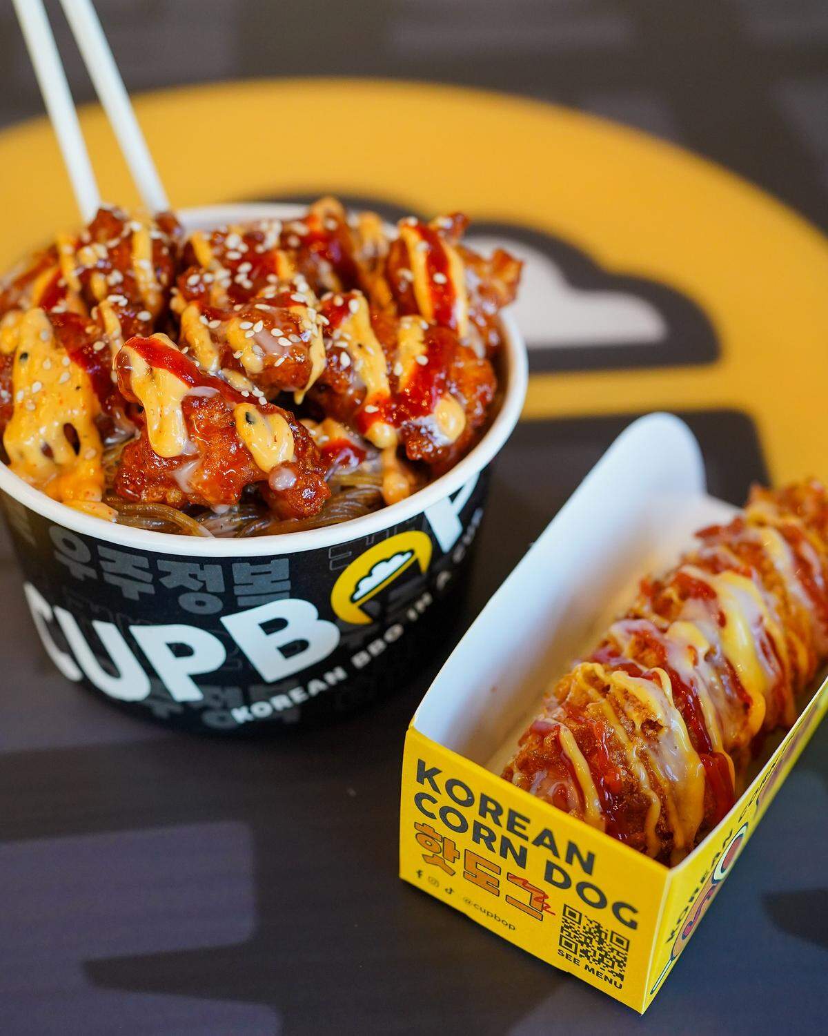 Cupbop specializes in Korean barbecue in a cup, along with other foods such as the K-Dawg, right.