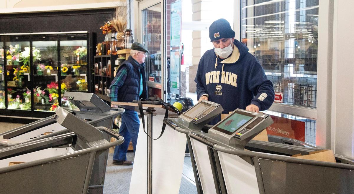 John Johnson staffs a demonstration area for a pilot trial of the high-tech shopping carts.