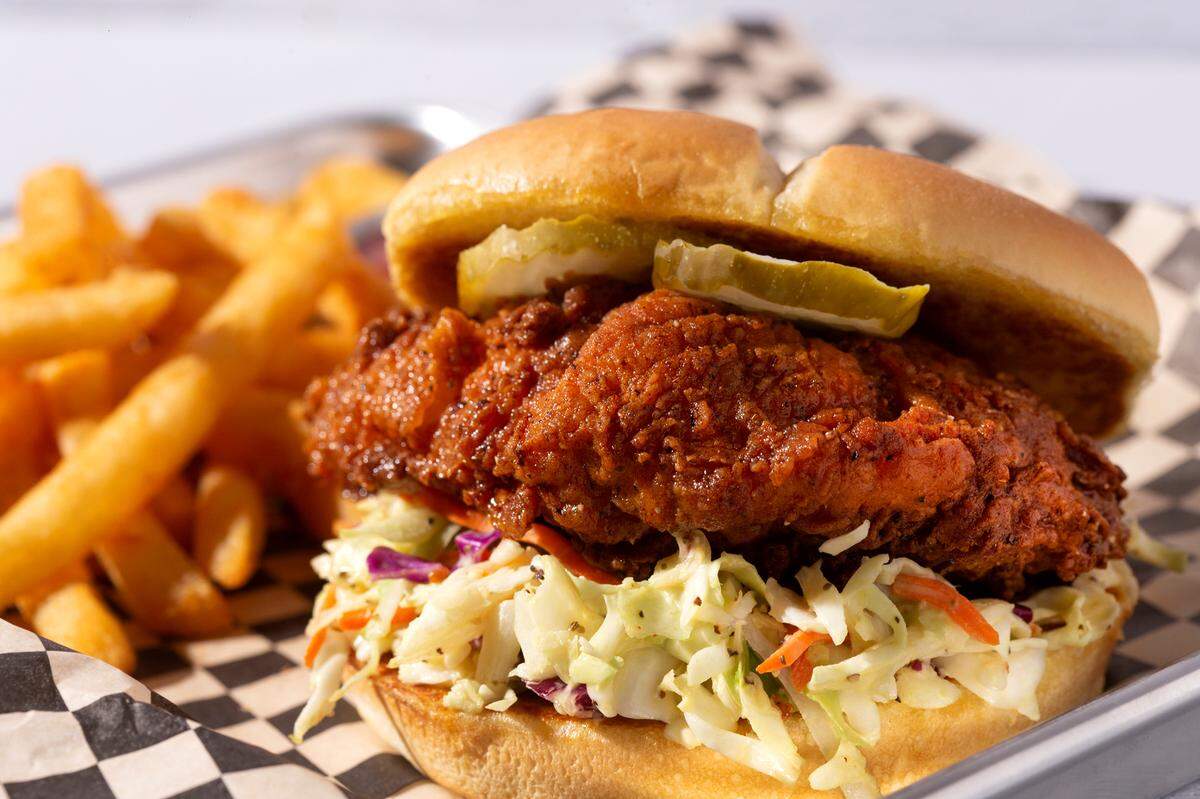 The Cluck is deep-fried Nashville chicken, housemade cole slaw, pickles and Cluck Sauce on a soft, buttered bun.