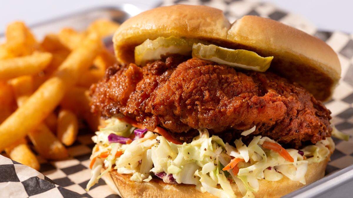 The Cluck is deep-fried Nashville chicken, housemade cole slaw, pickles and Cluck Sauce on a soft, buttered bun.