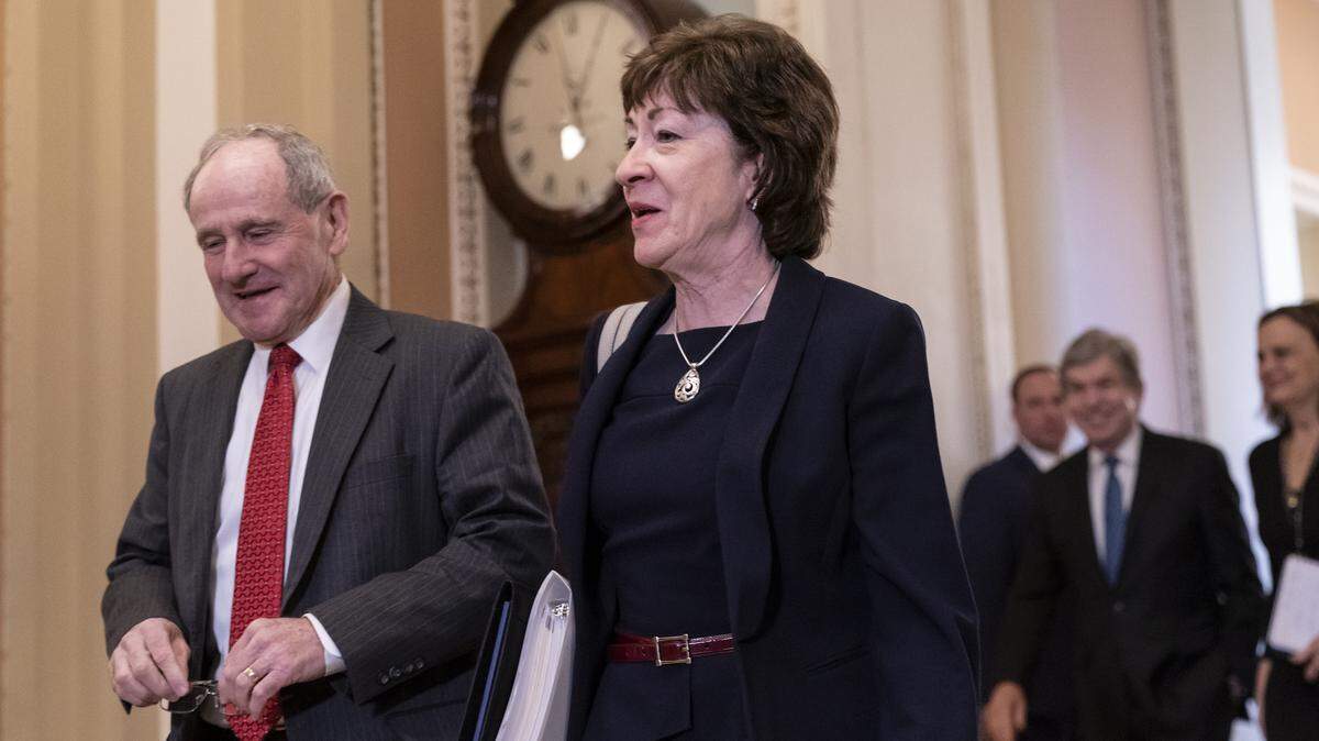 Sen. Jim Risch, R-Idaho, chairman of the Senate Foreign Relations Committee, left, walks with Sen. Susan Collins, R-Maine, as they arrive at the Senate for the start of the impeachment trial of President Donald Trump on charges of abuse of power and obstruction of Congress, at the Capitol in Washington, Tuesday, Jan. 21, 2020. (AP Photo/J. Scott Applewhite)