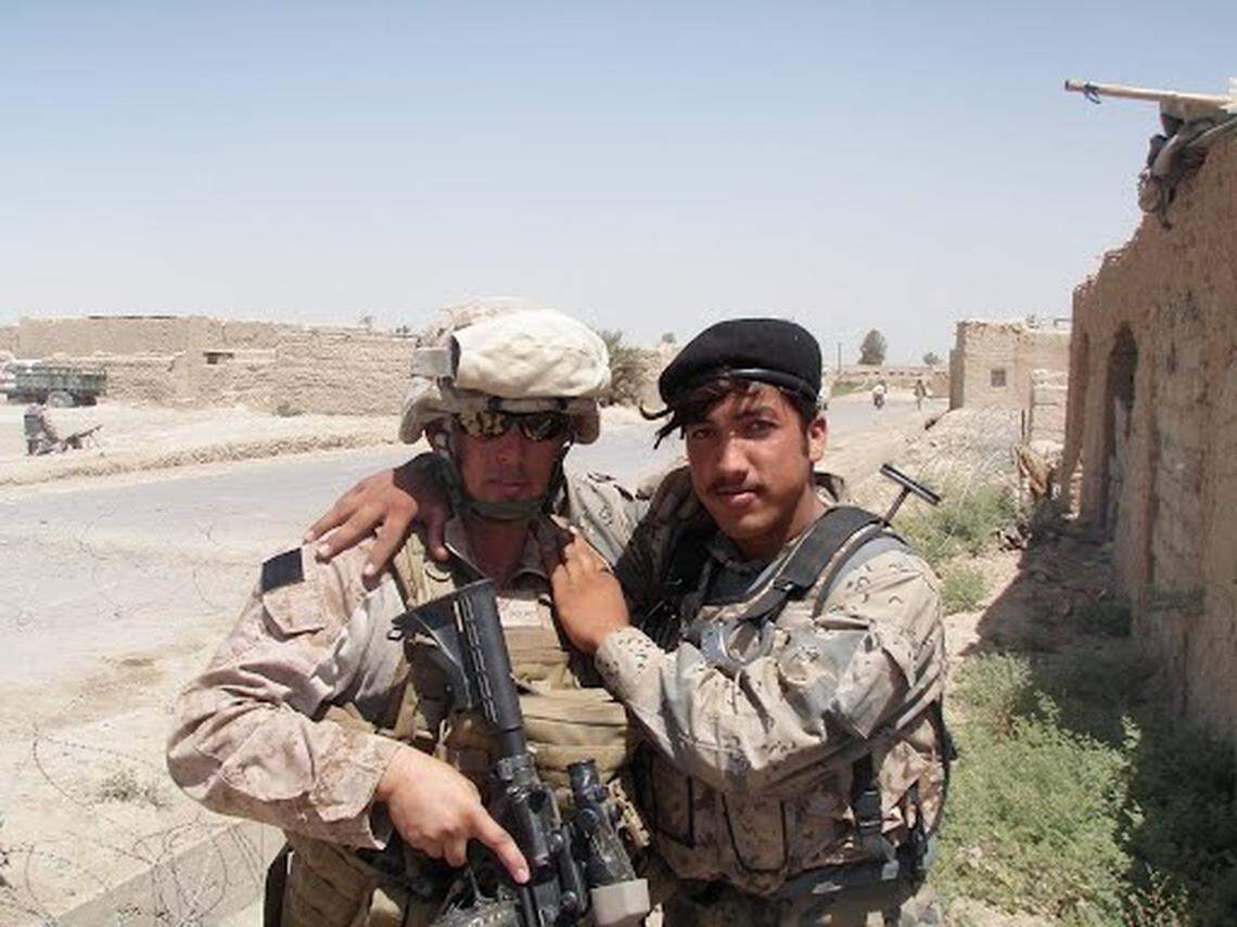Gunnery Sgt. Robert Holmes poses with an Afghan border police officer in Garmsir, Afghanistan, in 2010.