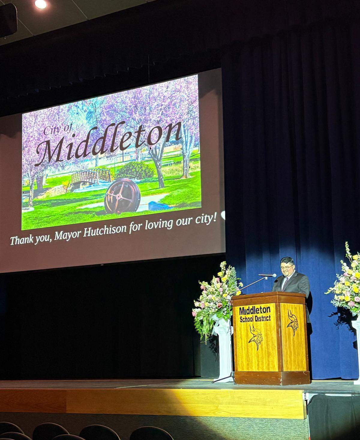 Pastor Jeremiah Campos leads the service at Middleton High School. 