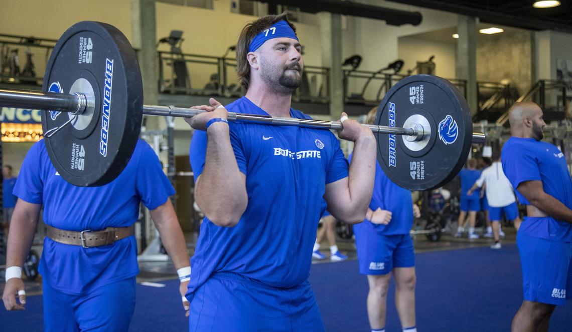 Boise State offensive lineman John Molchon hefts weights during an afternoon weight workout.