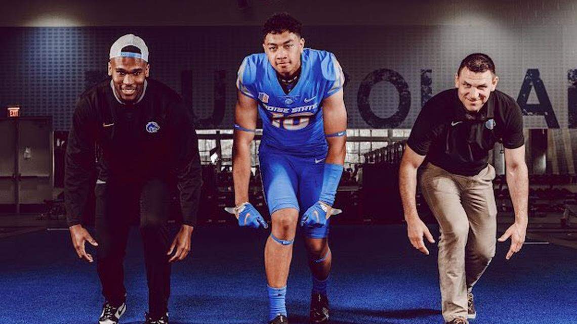 Bishop Gorman linebacker Jonah Lea’ea flexes with Boise State edge coach Kelly Poppinga, right, and graduate assistant Jabril Frazier during his visit to Boise on April 11.