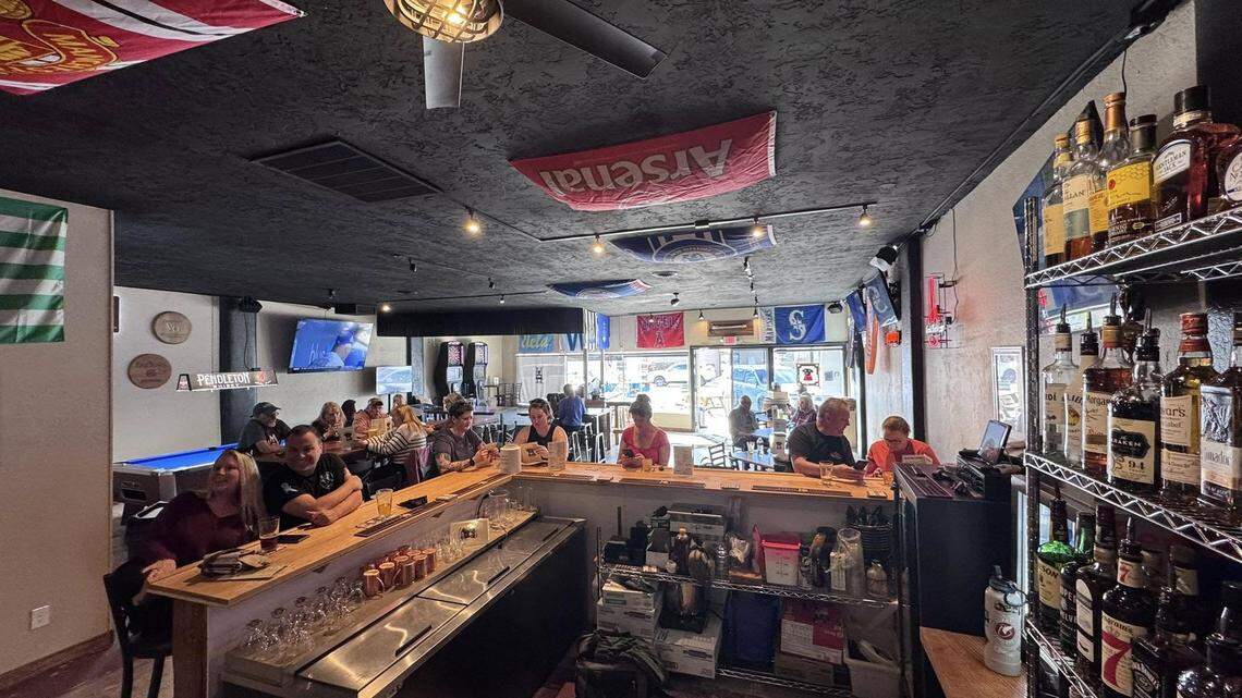 Customers enjoy drinks at Black Dog Bar, which opened recently on Orchard Street.